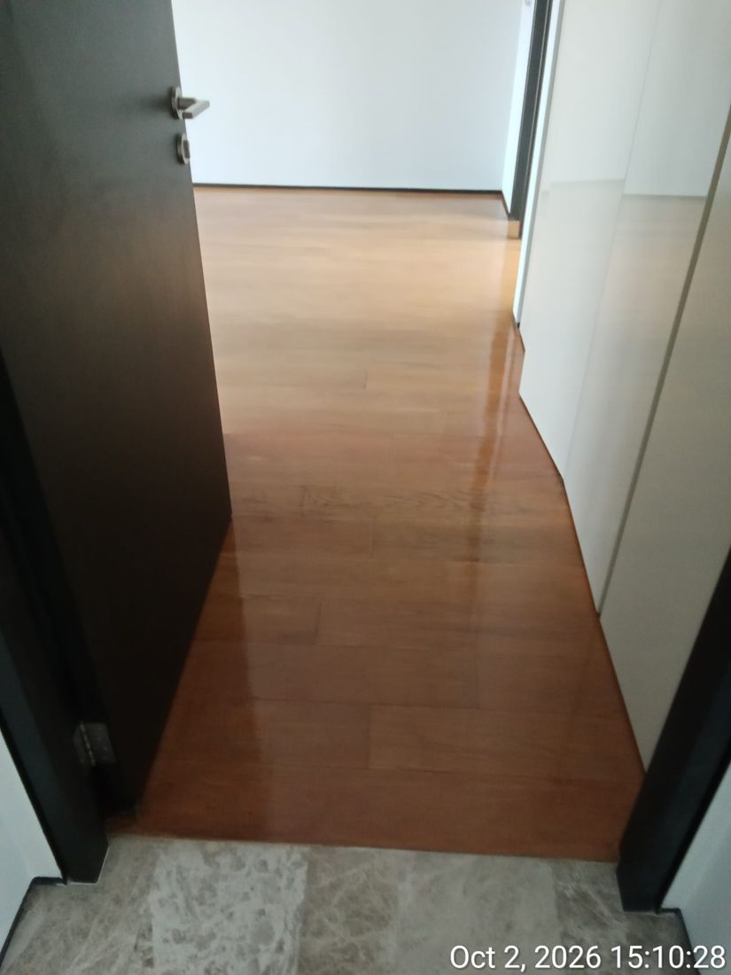 Glossy strip parquet corridor after varnishing