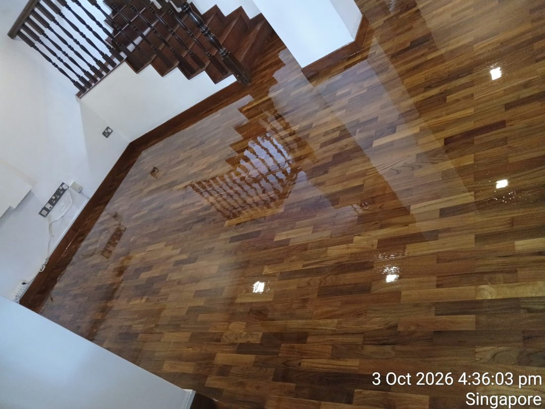 Glossy strip parquet hall at the foot of a timber staircase