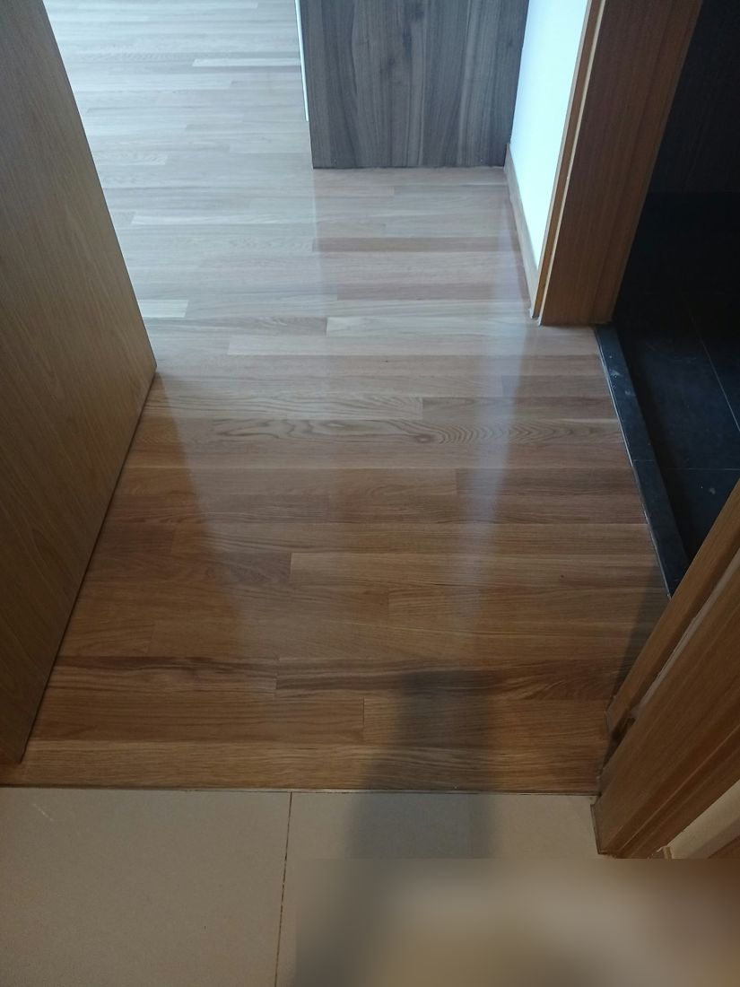 Light oak strip floor at a doorway after varnish